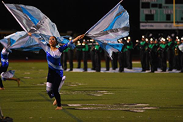 Color guard member sophomore Sabrina Wong performs in this year’s band field show “On Cloud Nine” at Sounds of Conejo—an event in which eight high school marching bands from across the region perform one last time before the fall competition season.