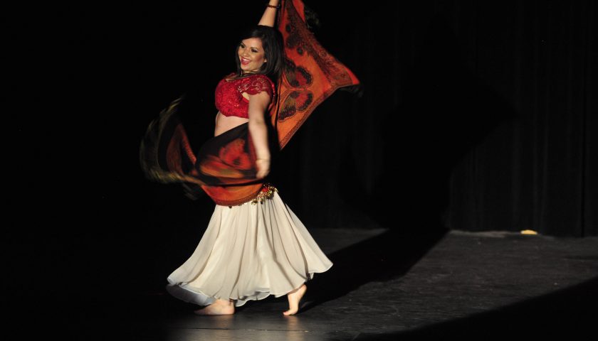 TWIRLING TALENT—Alumna Emily Hops performs a belly dancing piece in the PAC.