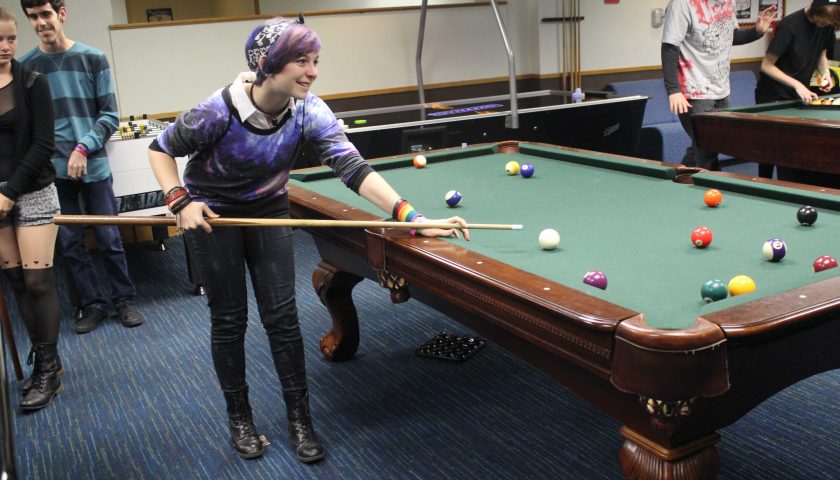 PLAYING POOL WITH HER CREW—An Agoura High School student plays pool and hangs out with her friends at the annual Gay Straight Alliance Dance. This year’s dance was called the Rainbow Dance because it was held on the Friday before Saint Patrick’s Day. Hosted and organized by Newbury Park High School, the event invited all the GSA clubs in Marmonte.