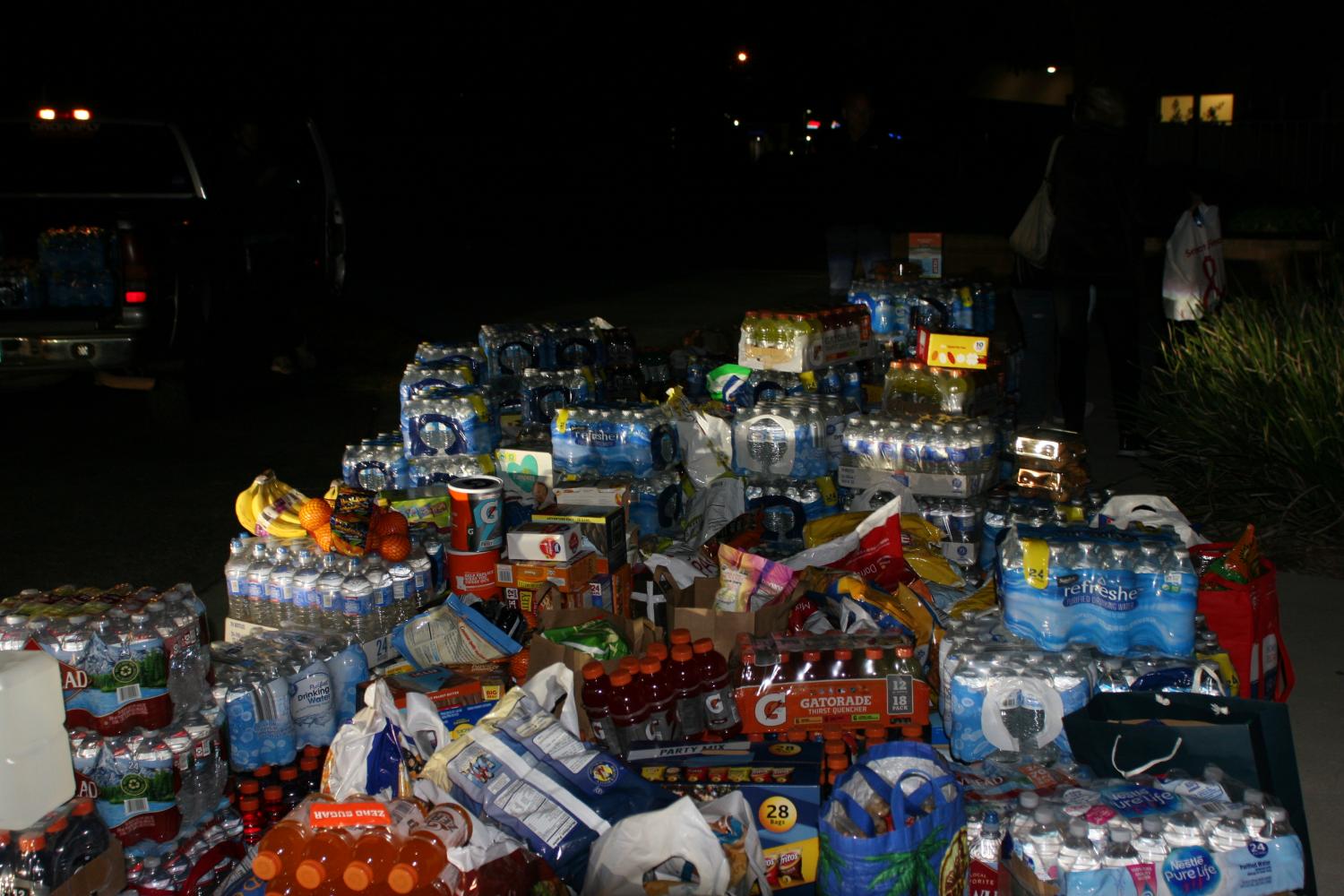 A Pile of Support -- Donations pile up outside of the TOHS gym. Families took photos with the ever-growing pile, and left feeling proud and fulfilled. The firefighters receiving the goods were thankful for the support.