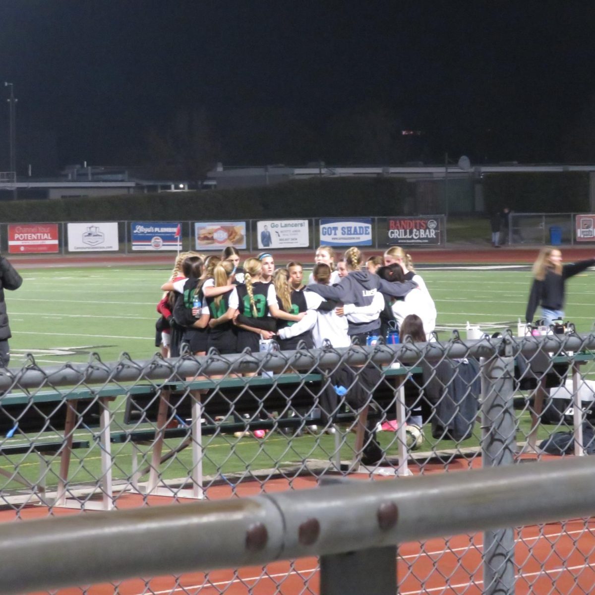 The soccer teams huddles up, ready for some game-winning plays