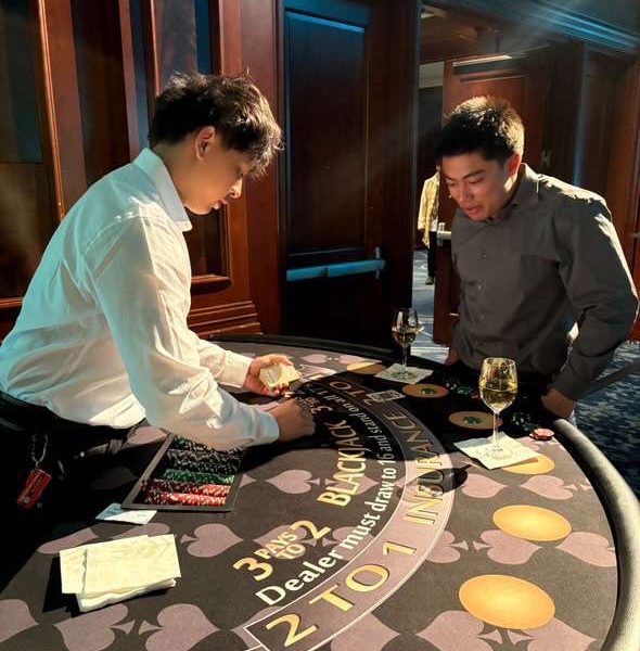 LETS DEAL WITH IT - Senior Tin Phan deals at poker tournament for an off campus job with a local gambling catering company.